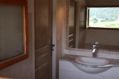 a bathroom with a sink and a mirror at L'Ensoleillée in Ménerbes