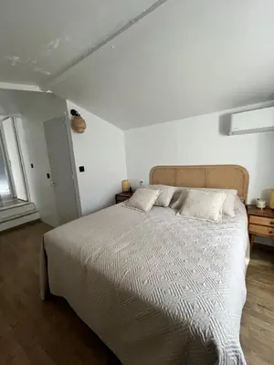 a bedroom with a large bed and a window at Appartement St Victor in Puyvert