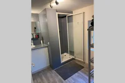 a bathroom with a shower and a glass door at Appartement St Victor in Puyvert