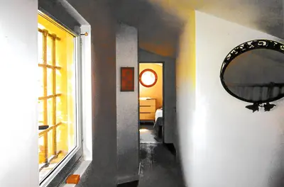 a hallway with a mirror and a room with a window at Appartement lumineux à Lançon-Provence, piscine partagée in Lançon-Provence