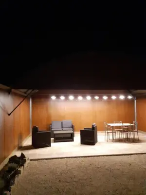 a stage with couches and a table in a room at DANSAVAN Chambres d Hôtes Gite in Oppède