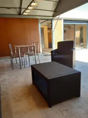 a room with a table and chairs and a couch at DANSAVAN Chambres d Hôtes Gite in Oppède