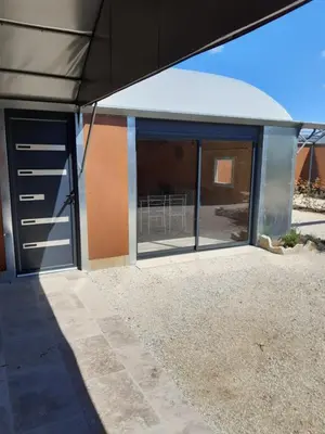 an open door of a house with a patio at DANSAVAN Chambres d Hôtes Gite in Oppède