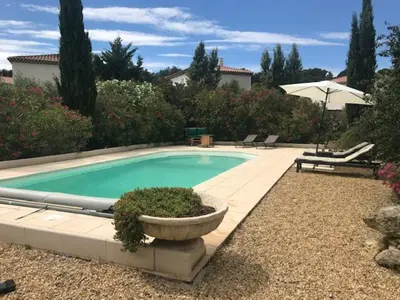 a swimming pool with a planter in a yard at Duplex pour 2 à 4 personnes avec piscine au coeur des vignes in Pélissanne