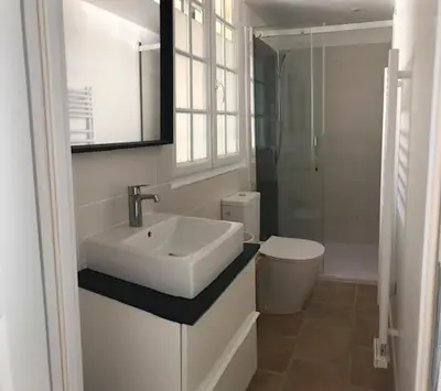 a white bathroom with a sink and a toilet at Duplex pour 2 à 4 personnes avec piscine au coeur des vignes in Pélissanne
