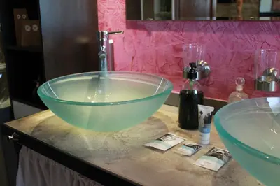 a bathroom with a glass bowl sink on a counter at Les Volets Bleus Provence in Salon-de-Provence