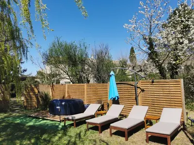 a patio with a table and chairs and an umbrella at Mas de Férigoulet -