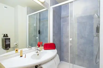 a bathroom with a white sink and a shower at ibis budget Cavaillon in Cavaillon