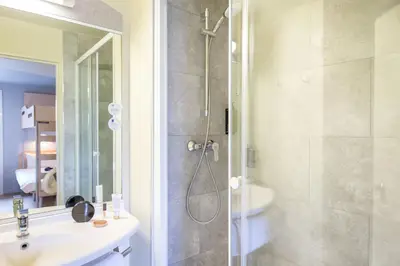 a bathroom with a shower and a sink at ibis budget Cavaillon in Cavaillon