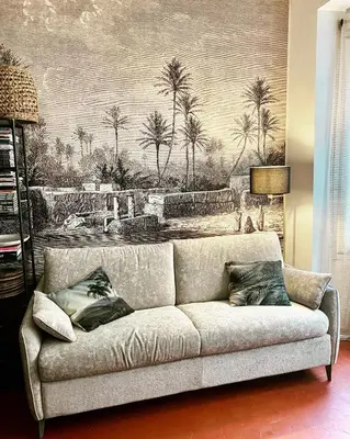 a couch in a living room with a painting of palm trees at Dar Saad Appartement terrasse climatisation centre d Aix in Aix-en-Provence