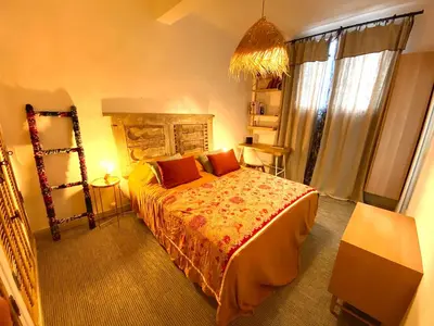 a bedroom with a large bed with red pillows at Dar Saad Appartement terrasse climatisation centre d Aix in Aix-en-Provence