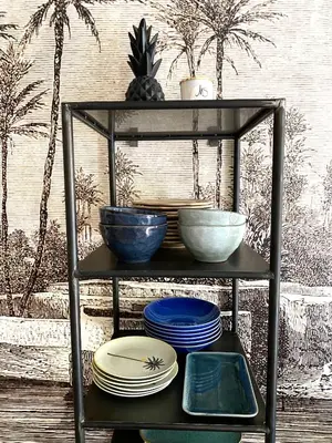 a shelf with plates and bowls on top of it at Dar Saad Appartement terrasse climatisation centre d Aix in Aix-en-Provence