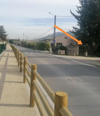 a wooden fence on the side of a road at la fée viviane et michel l'enchanteur in Robion en Luberon