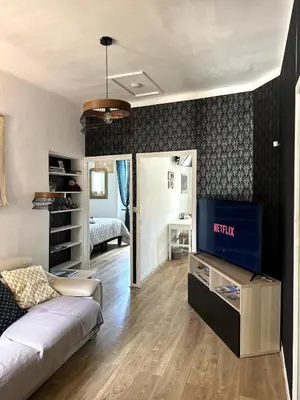 a living room with a couch and a tv at Ocra Pure in Roussillon