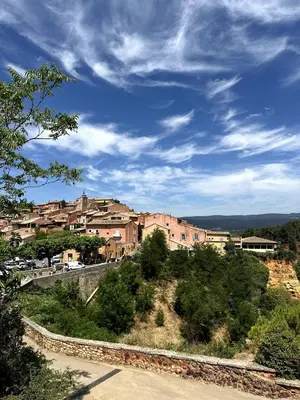 a town on top of a hill with buildings at Ocra Pure in Roussillon