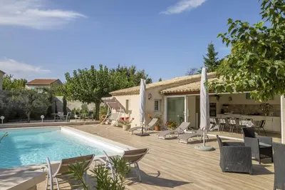 a patio with chairs and a swimming pool at Villa Mireillo in Noves