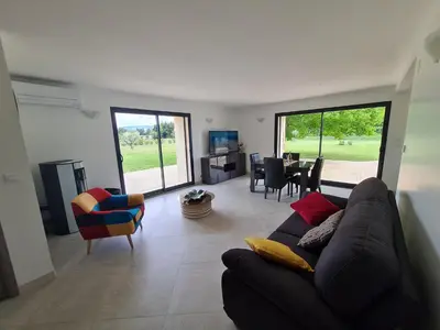 a living room with a couch and a table and chairs at Mas Des Fugueyrolles in Cavaillon