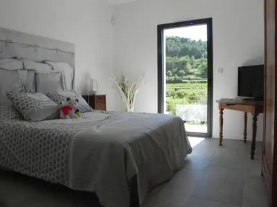 a bedroom with a bed with a teddy bear on it at Là Mésange de Venasque in Venasque