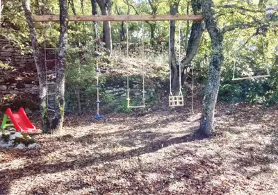 a swing set in a yard with trees at Santonne in Apt