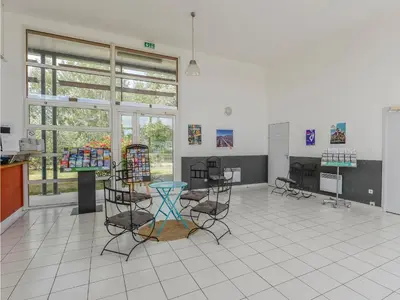 a room with chairs and a table in it at Residence Sun Hols Les Rives du Lac in Saint-Saturnin-lès-Avignon