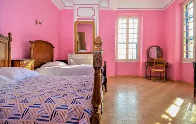 two beds in a room with pink walls at 2 Bedroom Beautiful Home In Avignon in Avignon