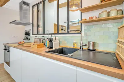 a kitchen with a sink and a counter top at Les Nids de la Diane - Appart'Conforts in Pertuis