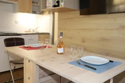 a bottle of wine sitting on a table with glasses at Floridianes by HRI in Aix-en-Provence