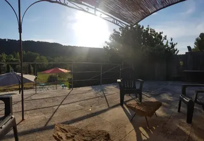 a tennis court with a chair on a tennis court at Moulin de Bonfilhon in Cornillon-Confoux