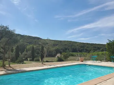 a swimming pool with a mountain in the background at Moulin de Bonfilhon in Cornillon-Confoux