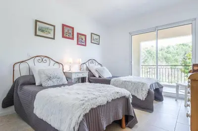 a bedroom with two beds and a window at Mas des Genêts in Manosque