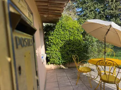 a bedroom with a large bed with pink flowers on the wall at Mas la Provence in LʼIsle-sur-la-Sorgue