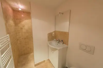 a small bathroom with a sink and a shower at La Treille et L'Impasse in Ansouis