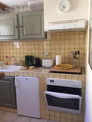 a small kitchen with a stove and a sink at Studio Idéal pour des moments d'exceptions in Cabrières-dʼAvignon