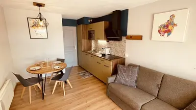 a living room with a couch and a table at Studio sur le Domaine du Golf de Pont Royal in Mallemort
