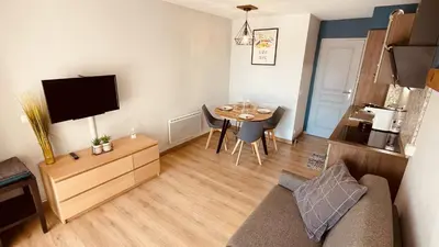 a living room with a couch and a table with a tv at Studio sur le Domaine du Golf de Pont Royal in Mallemort