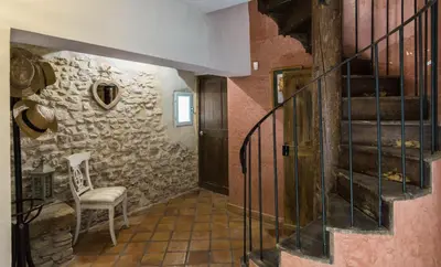 a staircase in a room with a stone wall at La Marisol in LʼIsle-sur-la-Sorgue