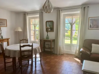 a living room with a table and a couch at Chez Suzanne in Bonnieux