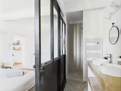 a bathroom with a black door and a sink and a bed at Magnifique Mas Provençal avec Piscine à Eygalières - 19 Couchages, 8 Chambres, Billard, et Plus ! - FR-1-599-3 in Eygalières