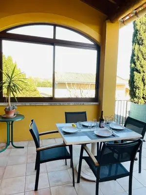 a dining room with a table and chairs and a window at Gîte Les Vignes in Carpentras