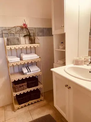 a bathroom with a towel rack next to a sink at Gîte Les Vignes in Carpentras