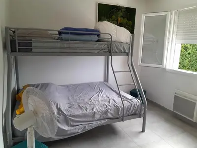 a bunk bed in a room with a window at Villa au pied du Ventoux in Mormoiron