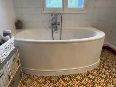 a bath tub with a faucet in a bathroom at VILLA BEL - Entre paradis et vignes in Ménerbes