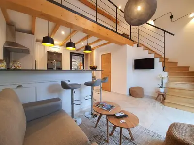 a living room with a couch and a table at Le Vallon des Pins in La Cride