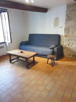 a living room with a blue couch and a coffee table at Charmante maison de village au cœur du Luberon in Pierrevert