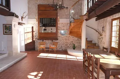 a room with a staircase and a table and chairs at typical mas provençal with swimming pool in a small hamlet near mouriès in the alpilles in provence- 8 persons in Mouriès