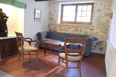 a living room with a couch and two chairs and a table at typical mas provençal with swimming pool in a small hamlet near mouriès in the alpilles in provence- 8 persons in Mouriès