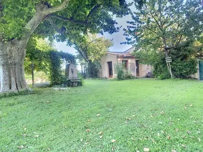 a house with a yard with a tree in front of it at LesArnauds in Aix-en-Provence