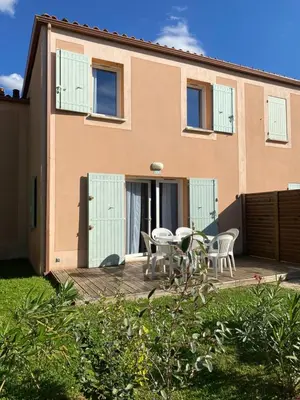 a patio with a table and chairs in front of a house at Les Demeures du Ventoux in Aubignan