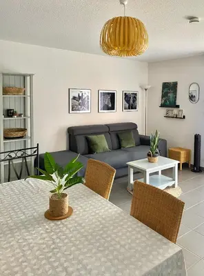 a living room with a table and a couch at Les Demeures du Ventoux in Aubignan