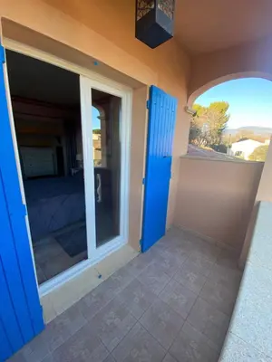 a room with a sliding door with a view of a bedroom at La Rose Des Vents in Modène
